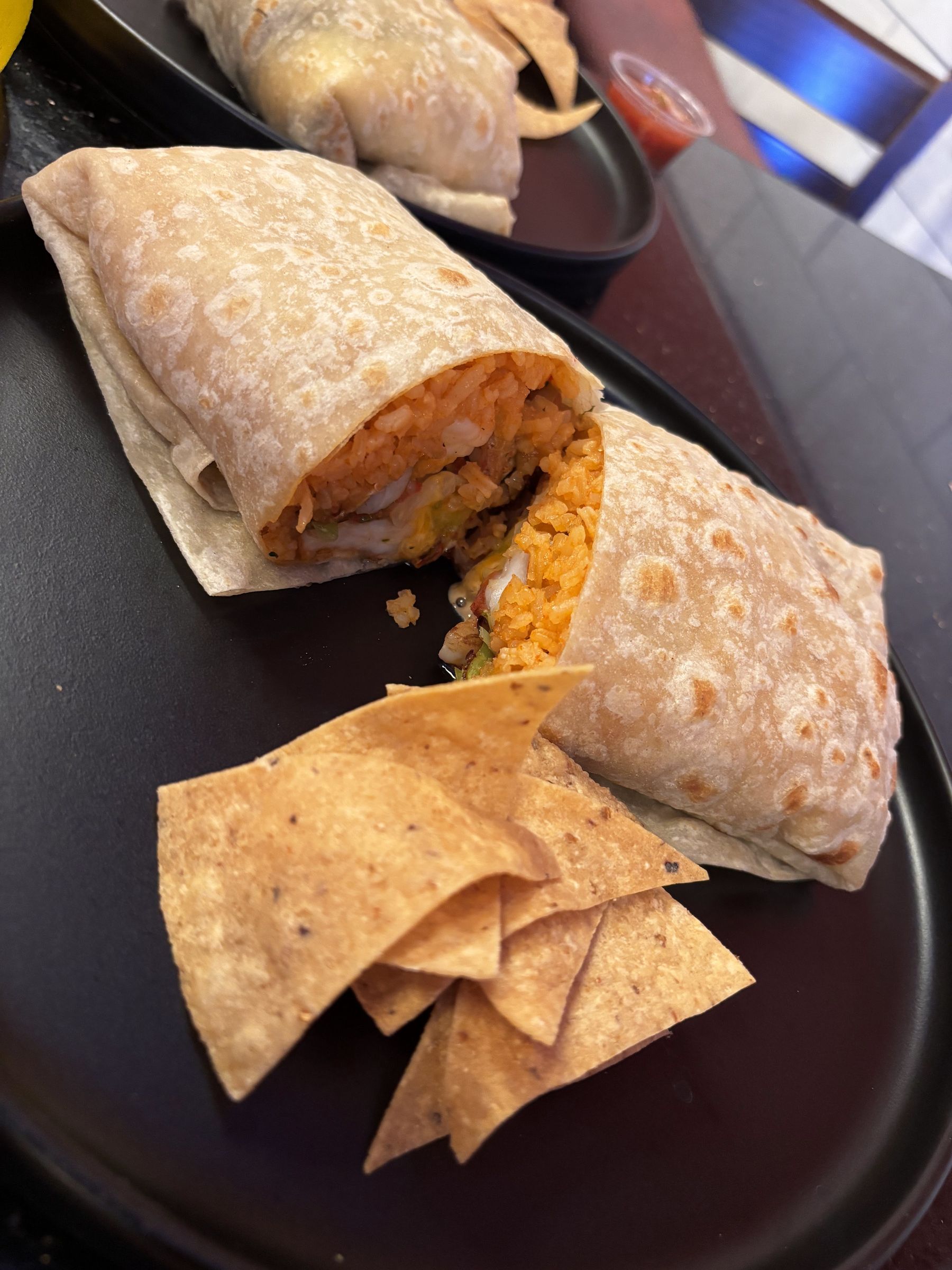 Burrito cut in half with tortilla chips
