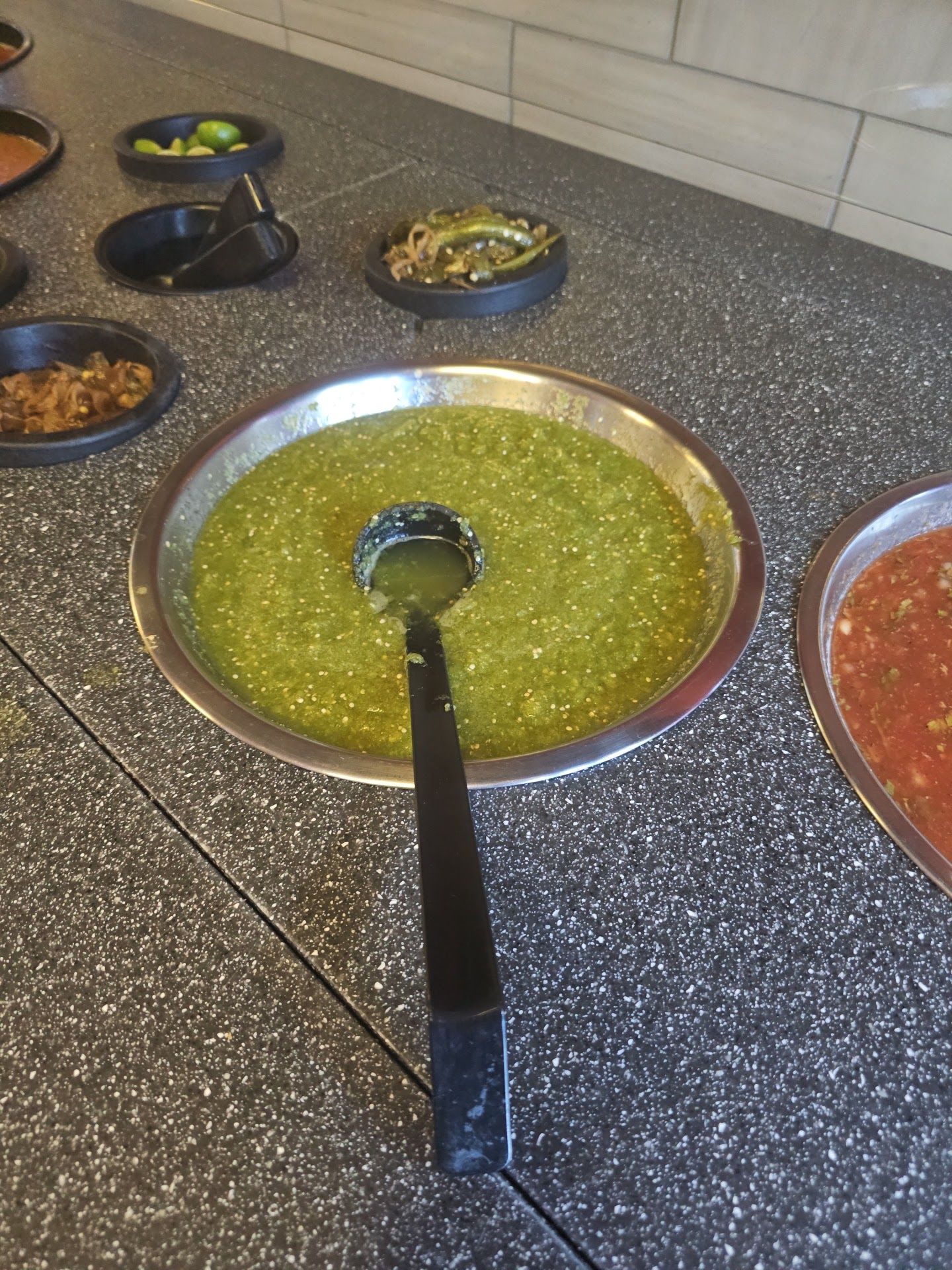 Salsa bar with fresh green and red salsas